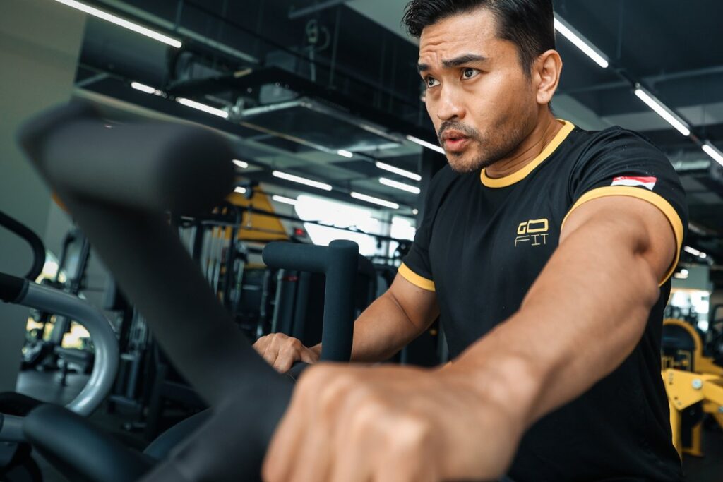 Member using an assault bike, an example of beginner friendly gym equipment