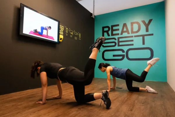 Two people doing the donkey kick at GoFit i-City